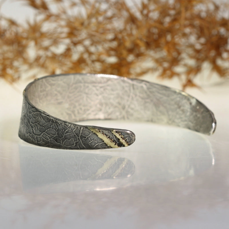 Narrow open cuff Simply metals with gold "sun"