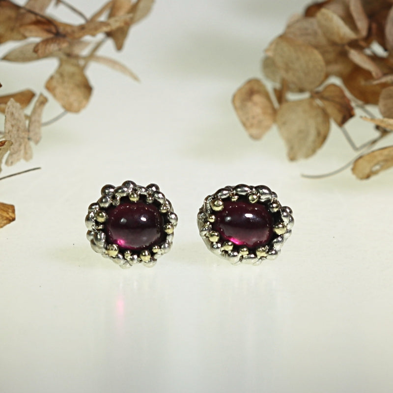 Stud earrings with oval rhodolite garnet