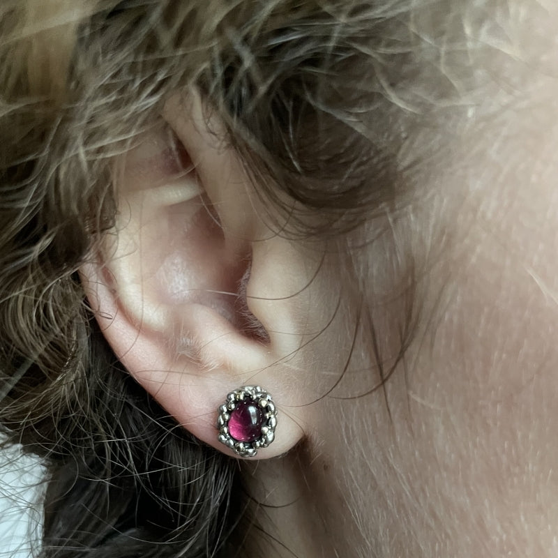 Stud earrings with oval rhodolite garnet
