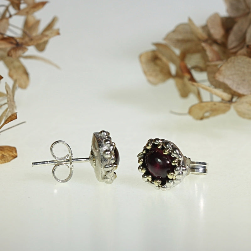 Stud earrings with oval rhodolite garnet