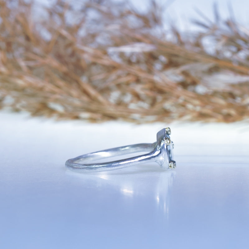 Tiny ring with geometric cut aquamarine