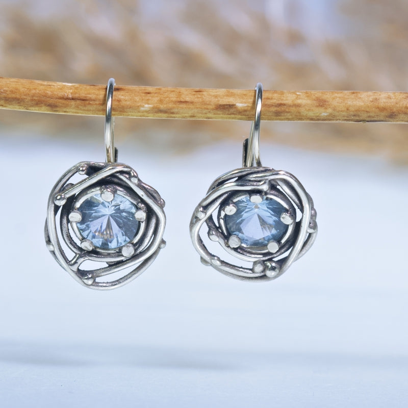 White gold earrings with round topaz
