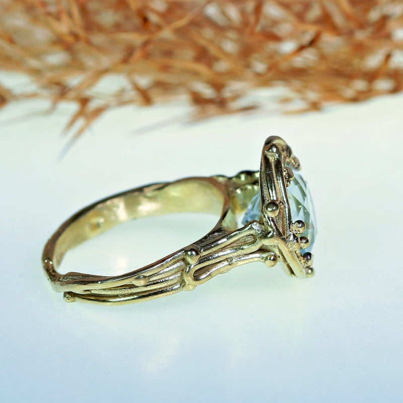 Gold ring with aquamarine in mandala cut