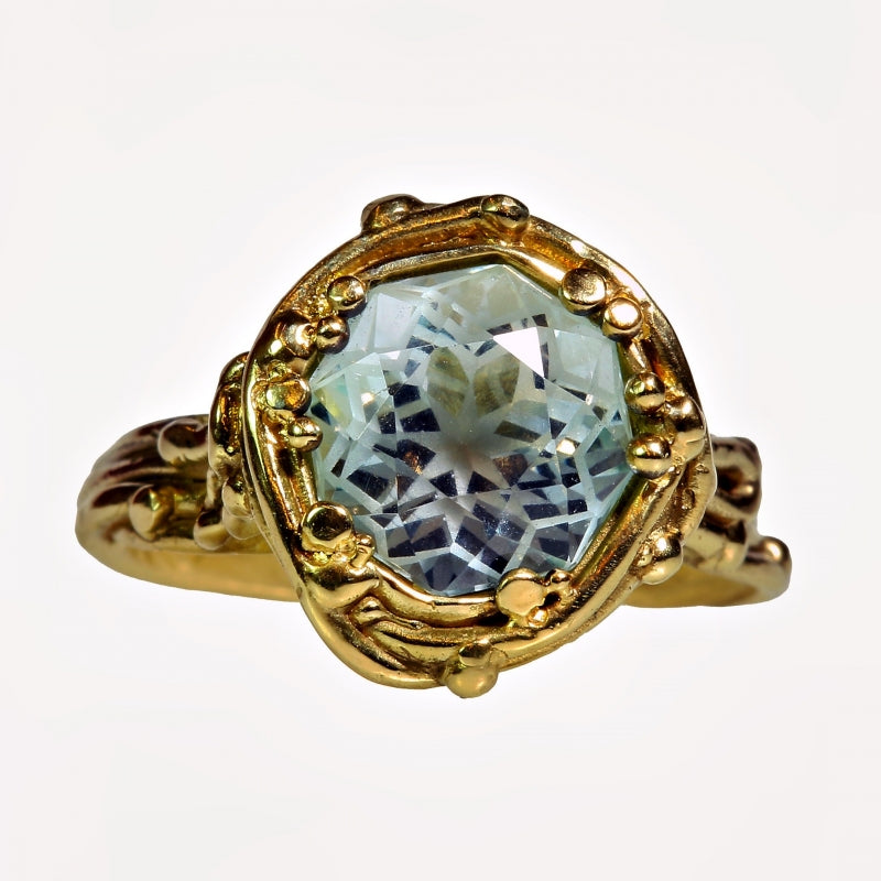 Gold ring with aquamarine in mandala cut