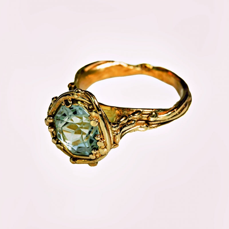 Gold ring with aquamarine in mandala cut