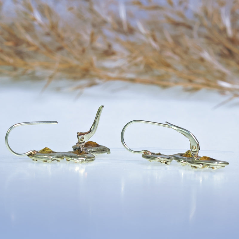 Gold earrings with three yellow sapphires