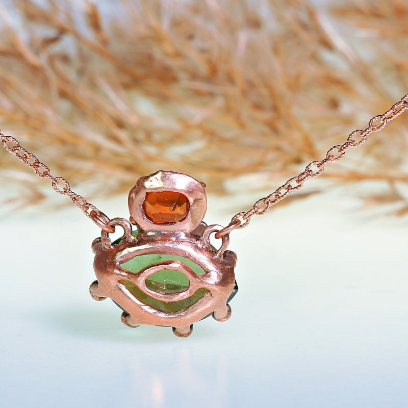 Gold necklace with moldavit and orange Umba sapphire