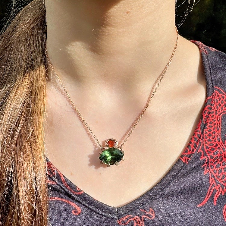 Gold necklace with moldavit and orange Umba sapphire