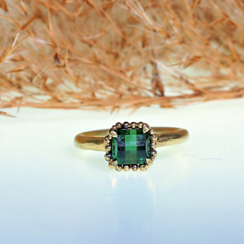 Gold ring with pixel cut tourmaline and halo