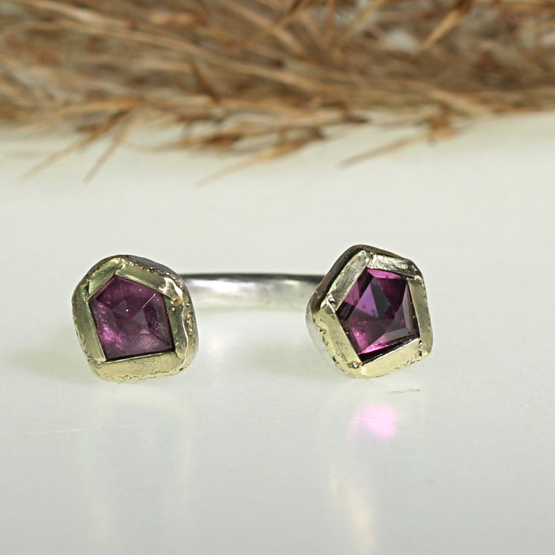 Open shape ring with two rhodolites garnets and gold lines