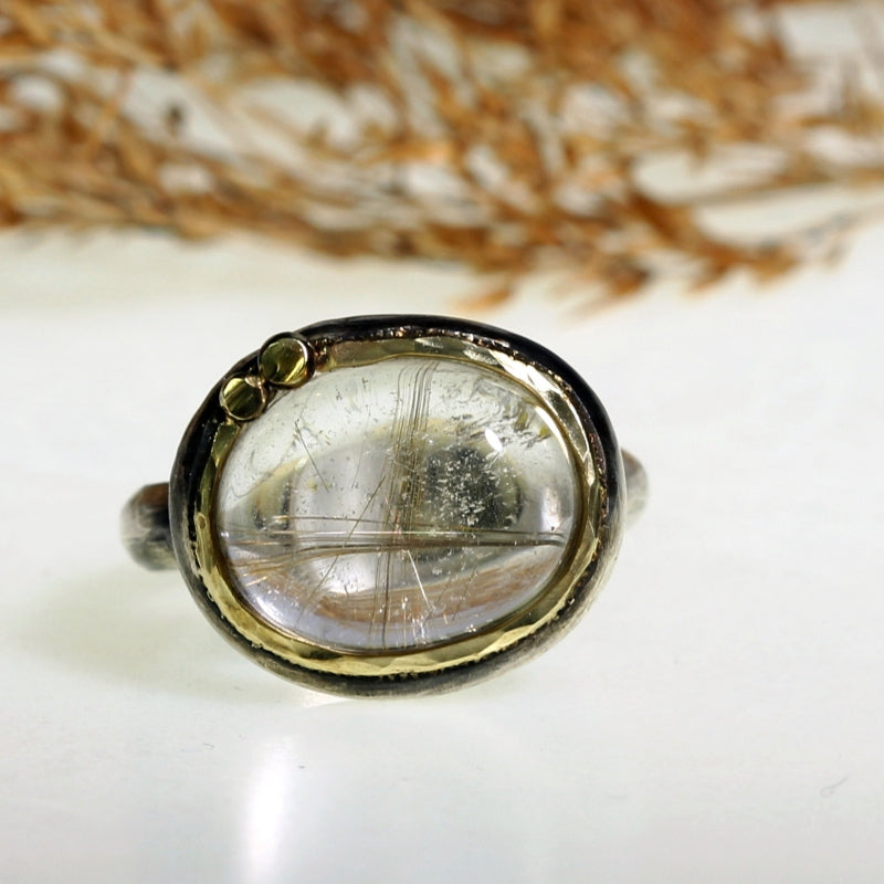 Ring with east-west setting gold rutile