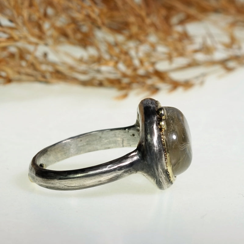 Ring with east-west setting gold rutile