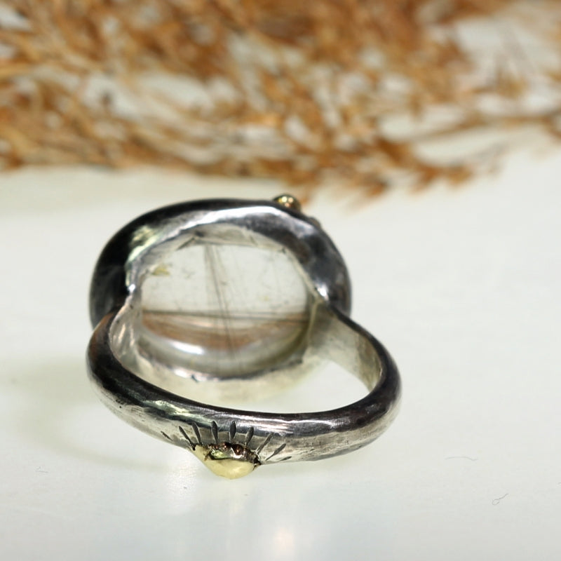 Ring with east-west setting gold rutile