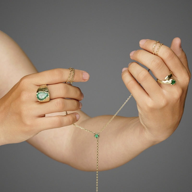 Statement gold ring with big emerald and hand carved band