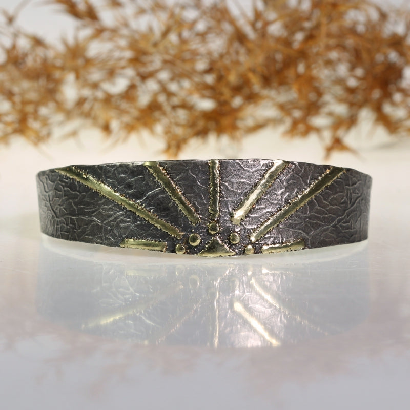 Narrow open cuff Simply metals with gold "sun"