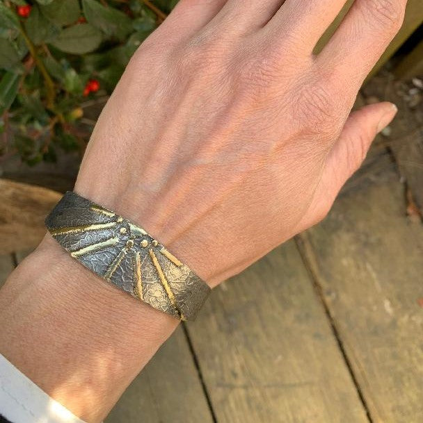 Narrow open cuff Simply metals with gold "sun"