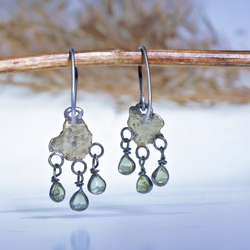 Hanging earrings with organic shape gold plates and peridots
