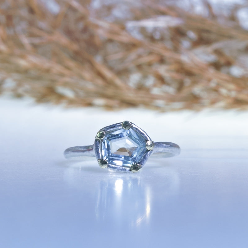 Tiny ring with geometric cut aquamarine