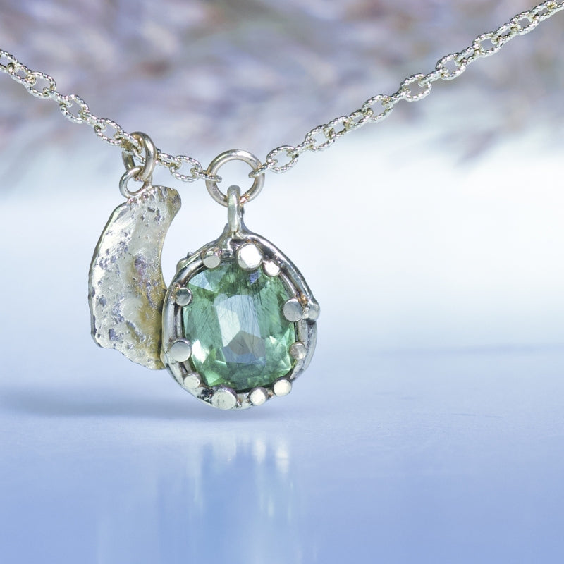 Gold necklace with peridot and halfmoon