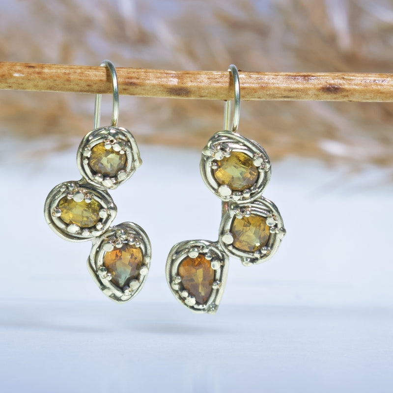 Gold earrings with three yellow sapphires