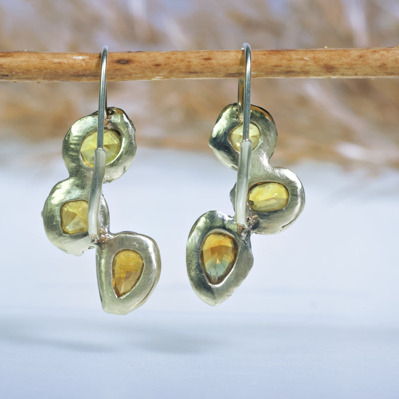 Gold earrings with three yellow sapphires