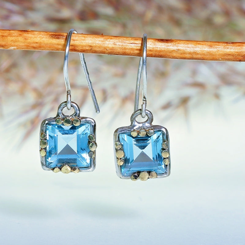 Hanging earrings with blue topazes