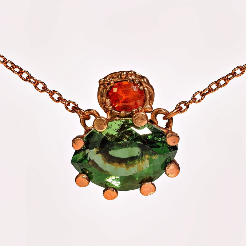 Gold necklace with moldavit and orange Umba sapphire