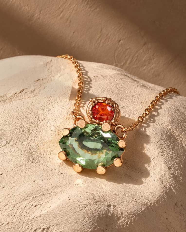 Gold necklace with moldavit and orange Umba sapphire