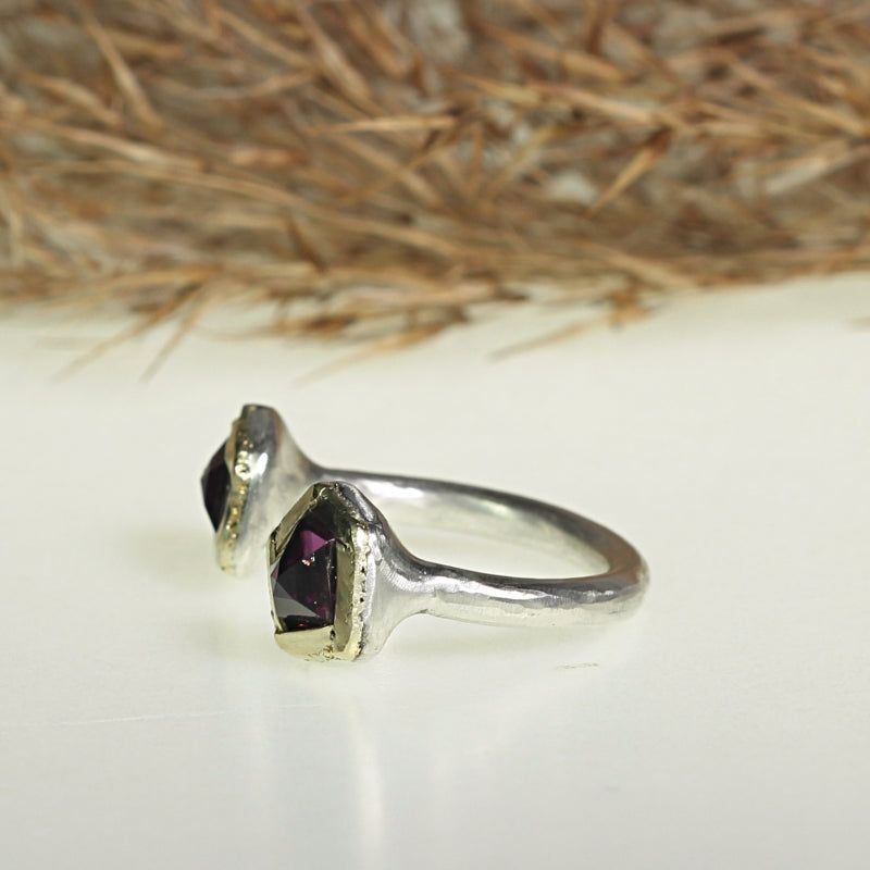 Open shape ring with two rhodolites garnets and gold lines