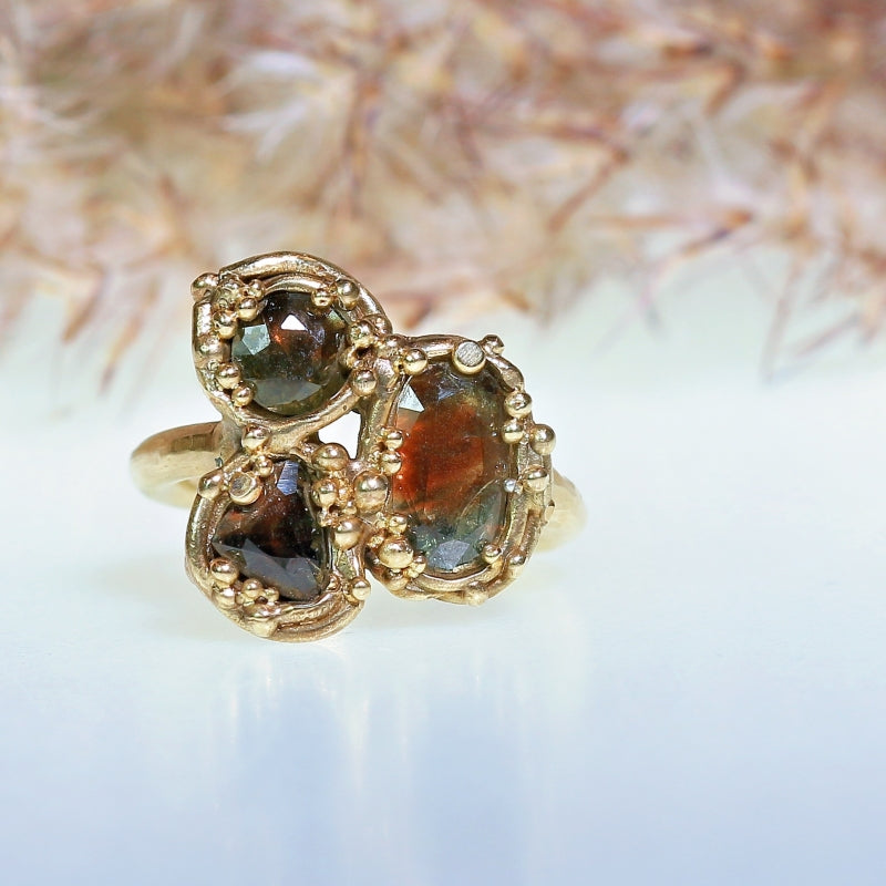Gold ring with three brown sapphires