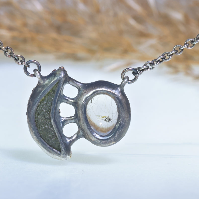 Necklace with moon shape moldavit and sagenit